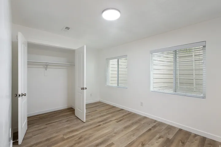 Unfurnished bedroom with light wood finished floors and a closet