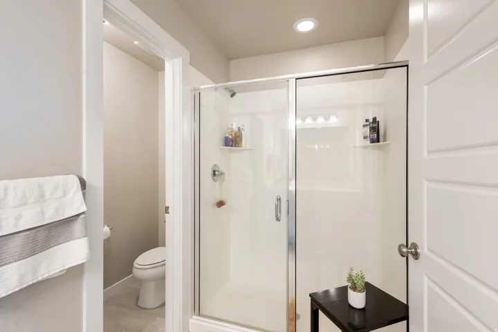 Bathroom with a stall shower and recessed lighting
