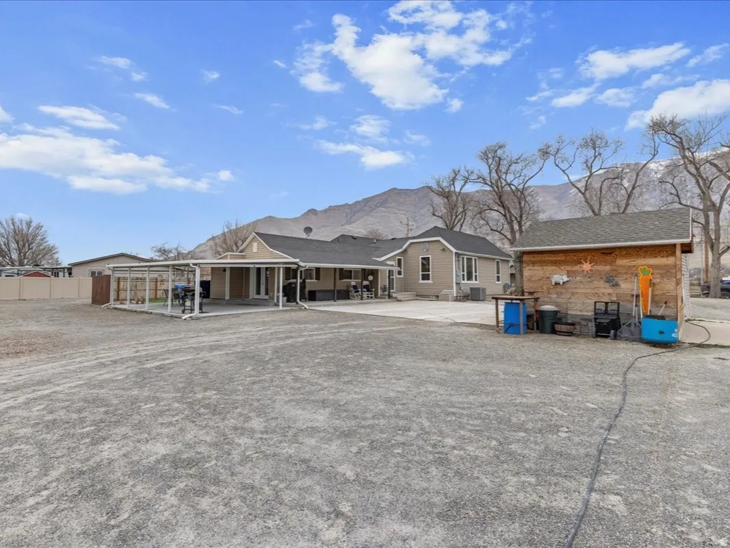 Back of house featuring a patio area and a mountain view