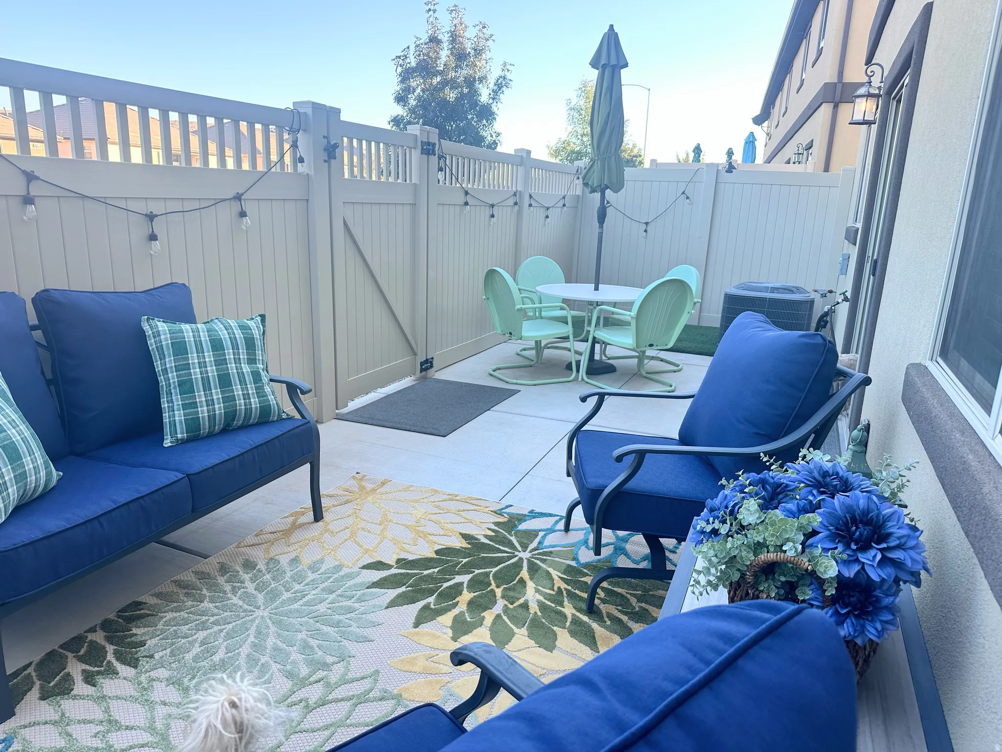 Fenced backyard with an outdoor hangout area, outdoor dining space, and a patio area