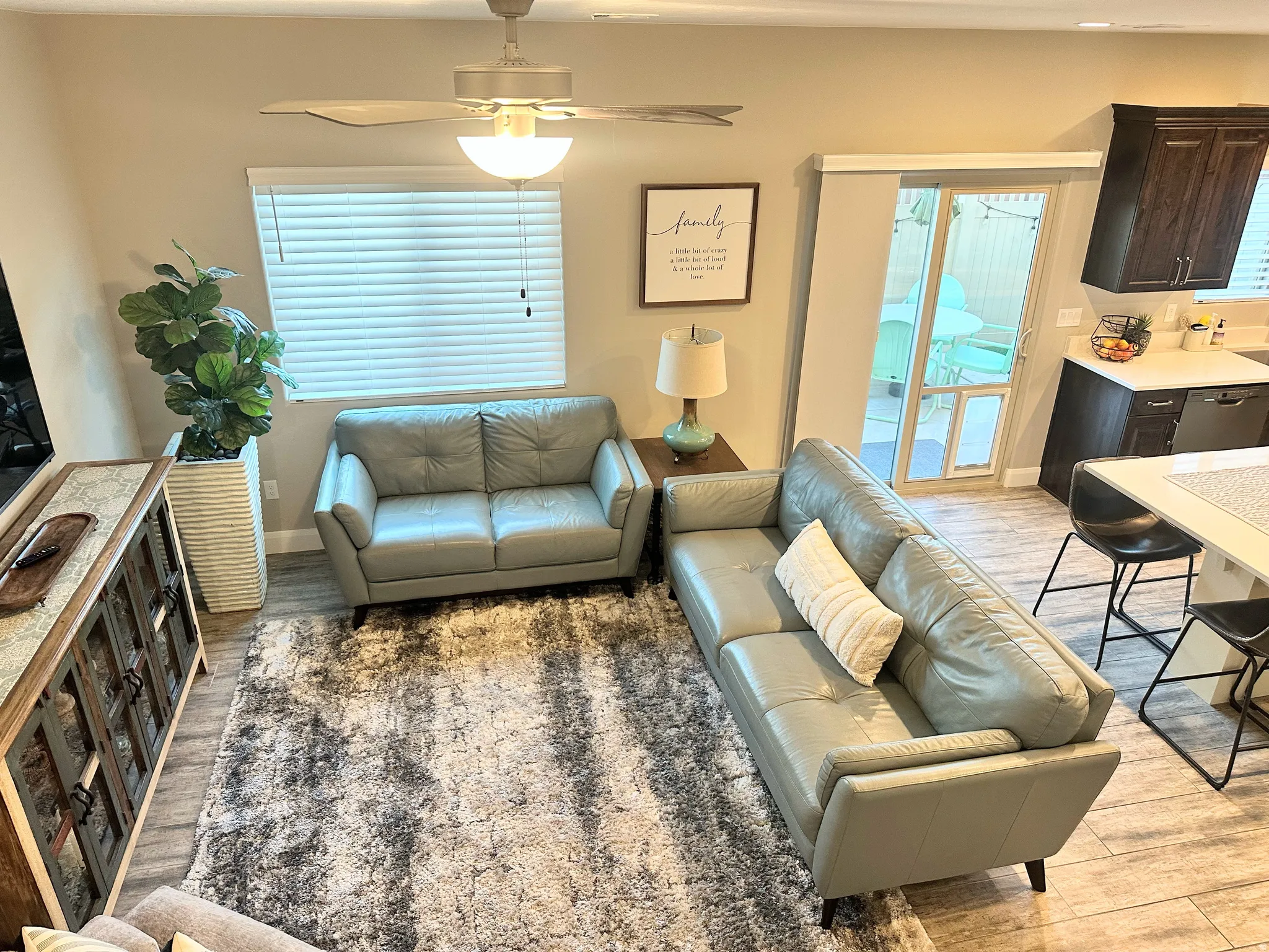 Living area with light wood-style floors and ceiling fan