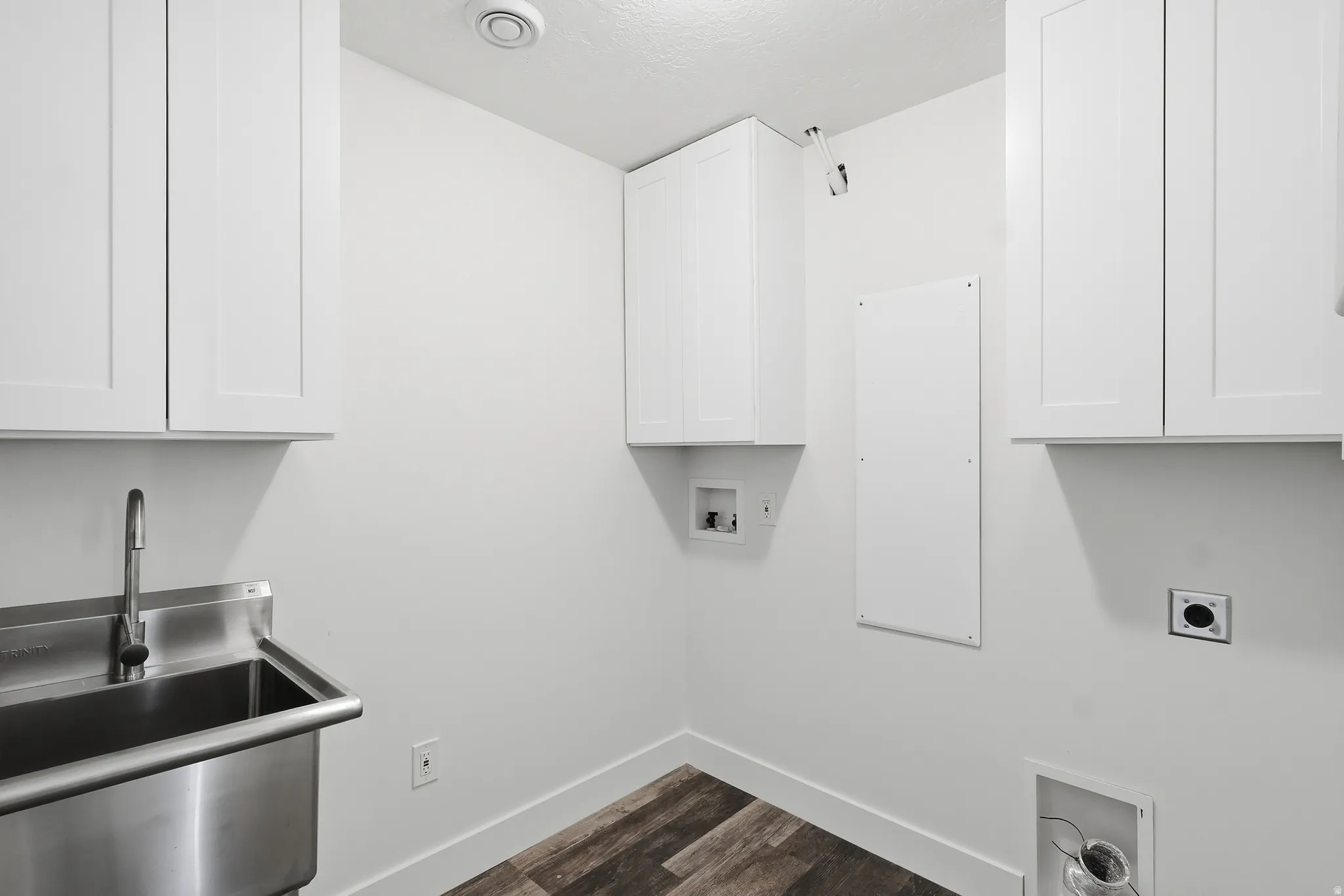 Laundry room featuring hookup for an electric dryer, hookup for a washing machine, cabinet space, and dark wood finished floors