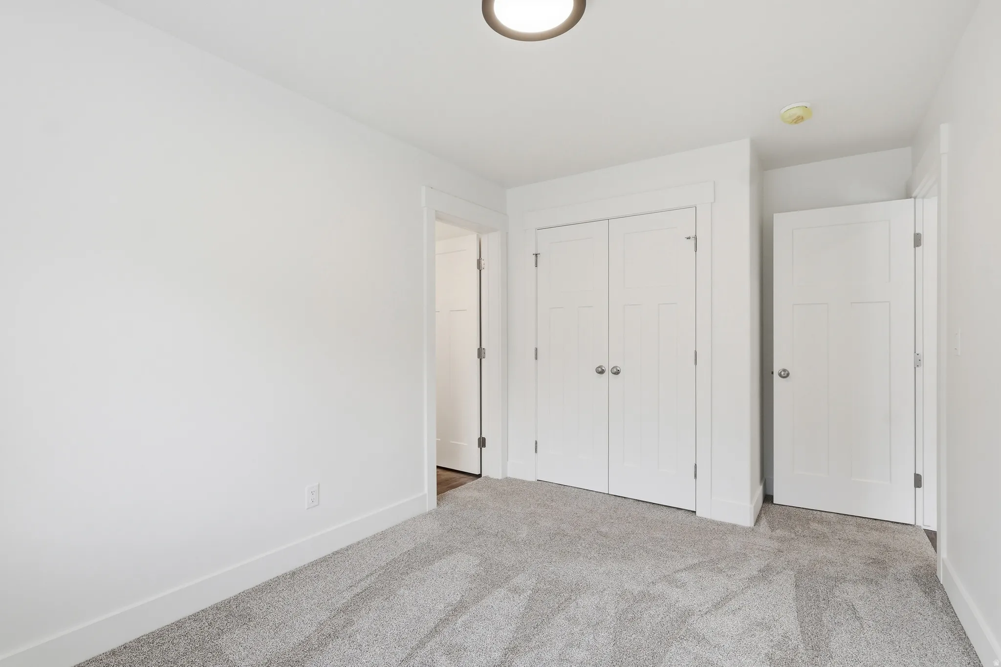 Unfurnished bedroom with carpet and a closet