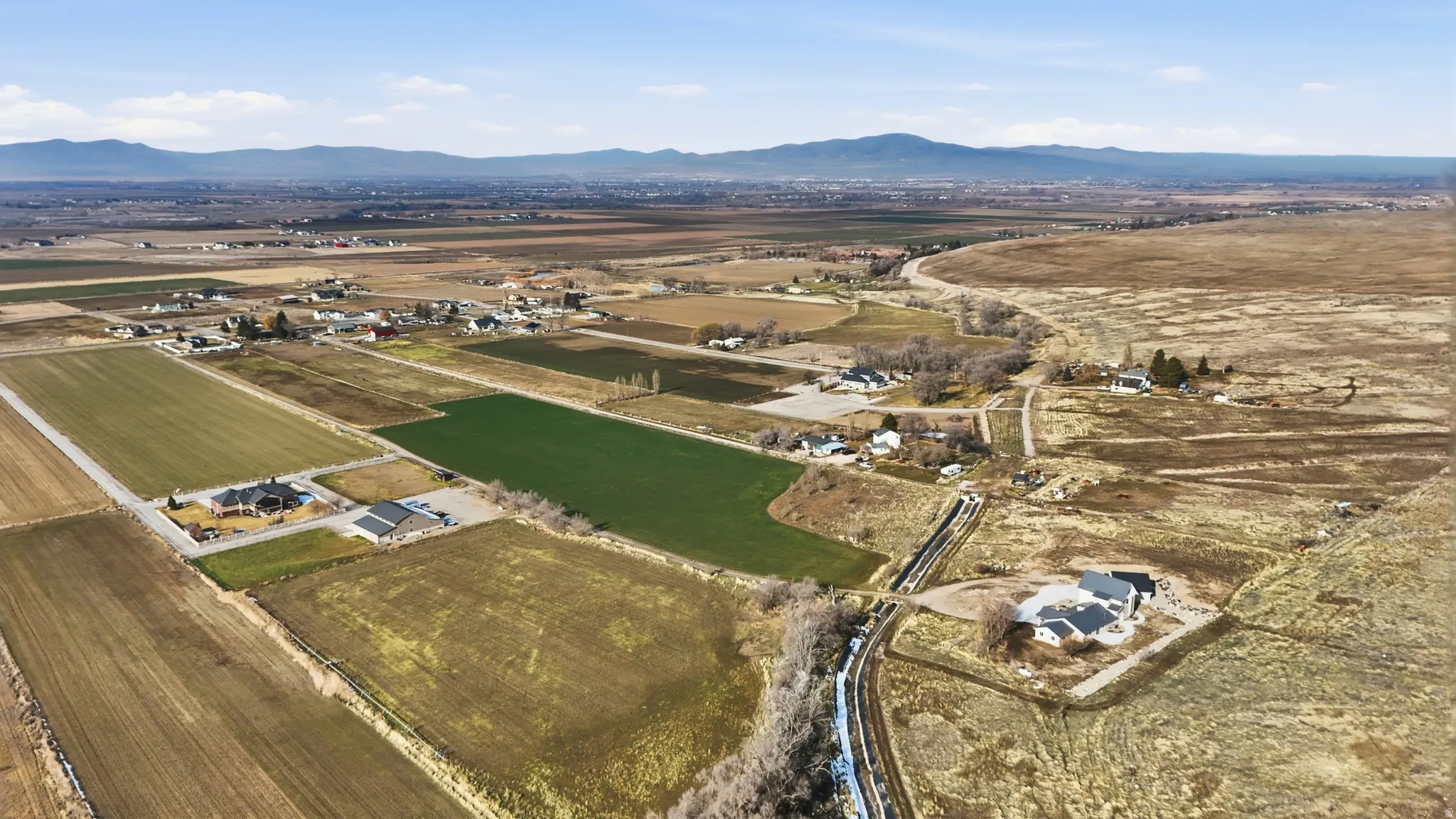 Aerial view of sparsely populated area with a mountain backdrop