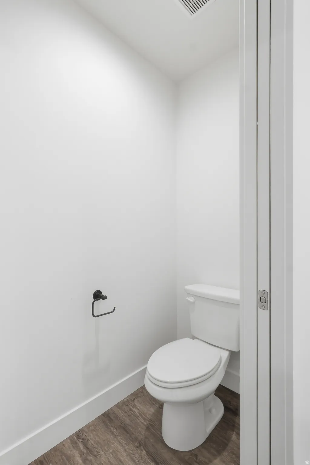 Main level bathroom with toilet behind pocket door