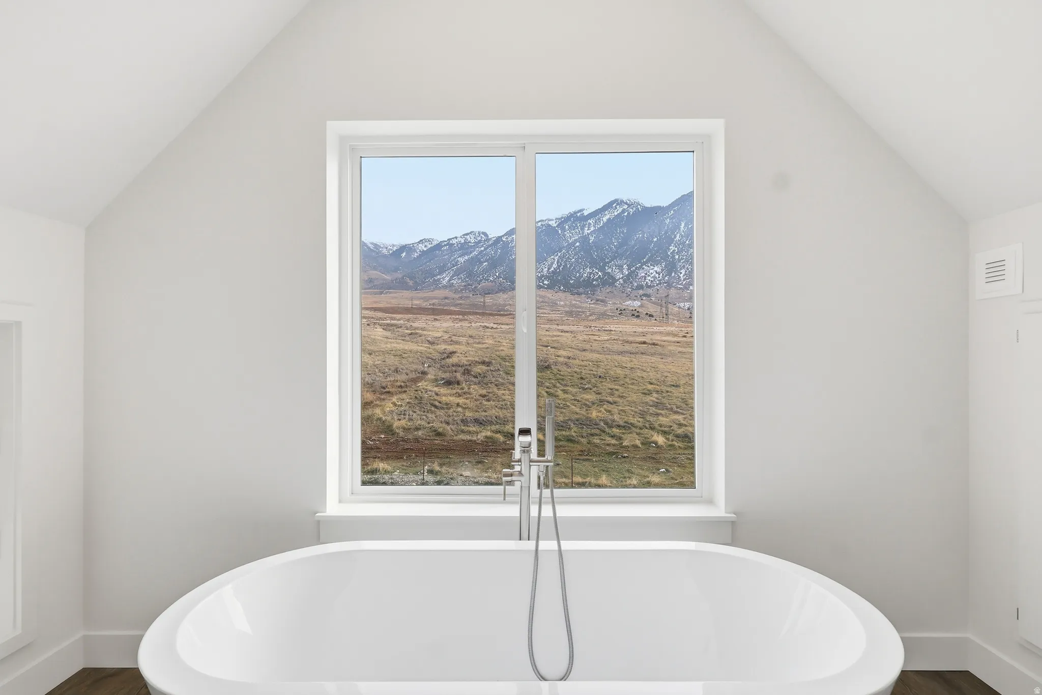 Bathroom with lofted ceiling, a freestanding bath,  and separate shower