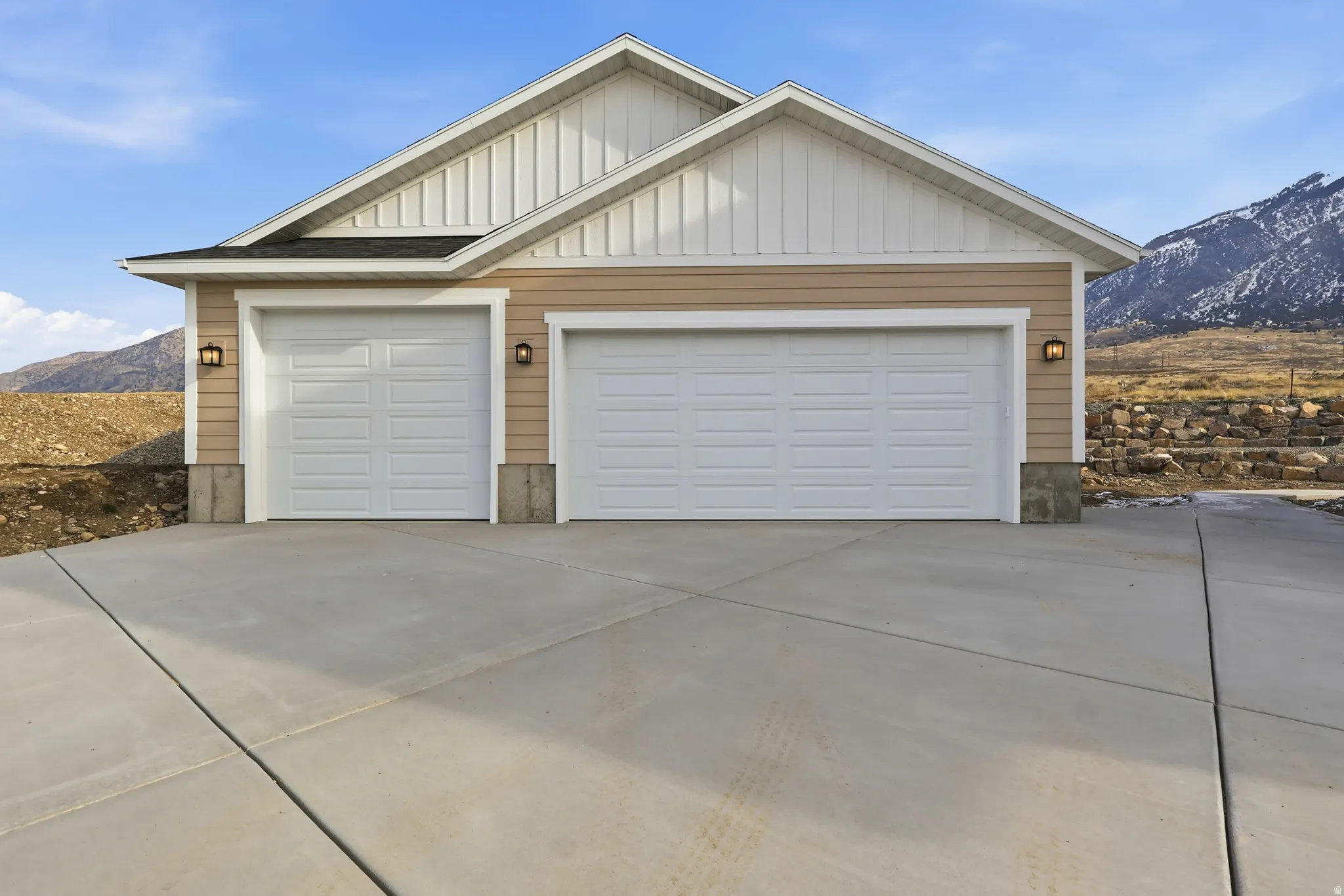 Garage featuring a mountain view and concrete driveway