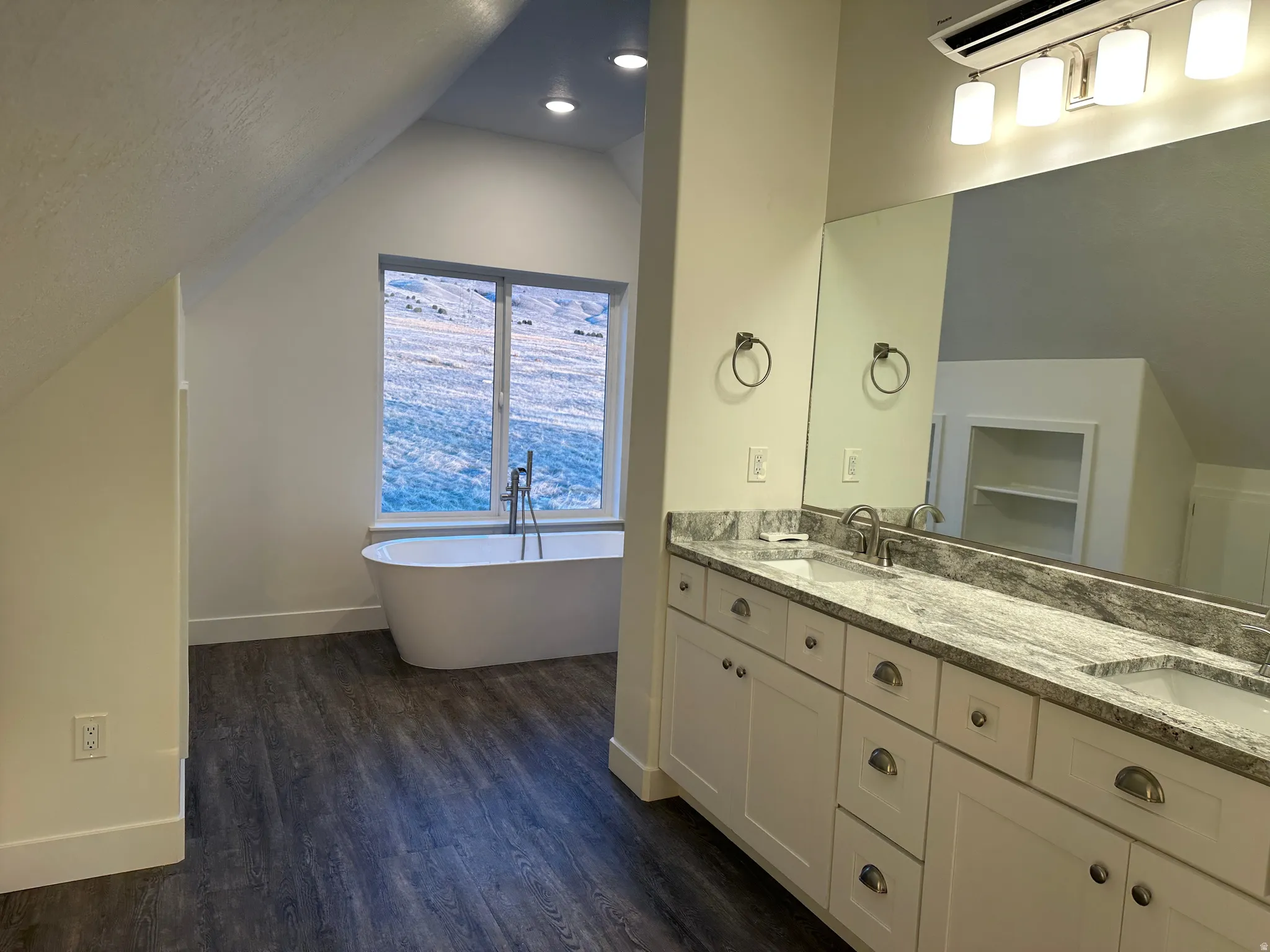 Full bath with double vanity, a freestanding tub and separate shower