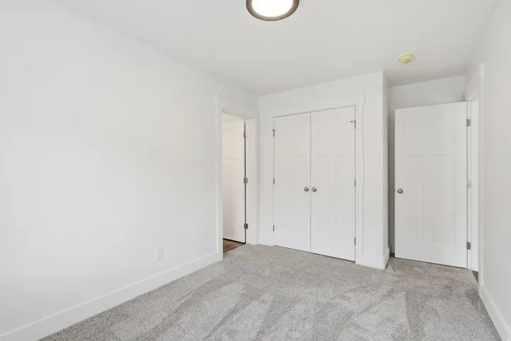 Unfurnished bedroom with carpet and a closet