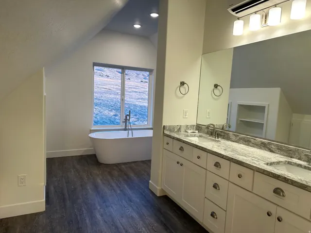Full bath with double vanity, a freestanding tub and separate shower
