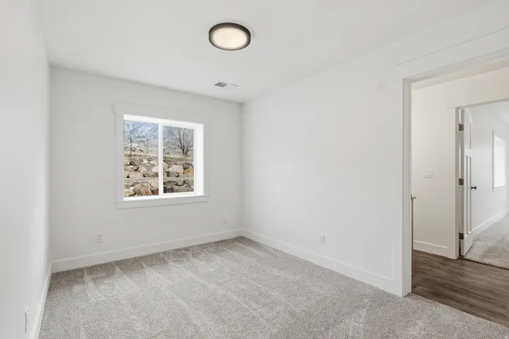 Unfurnished room with carpet flooring and baseboards