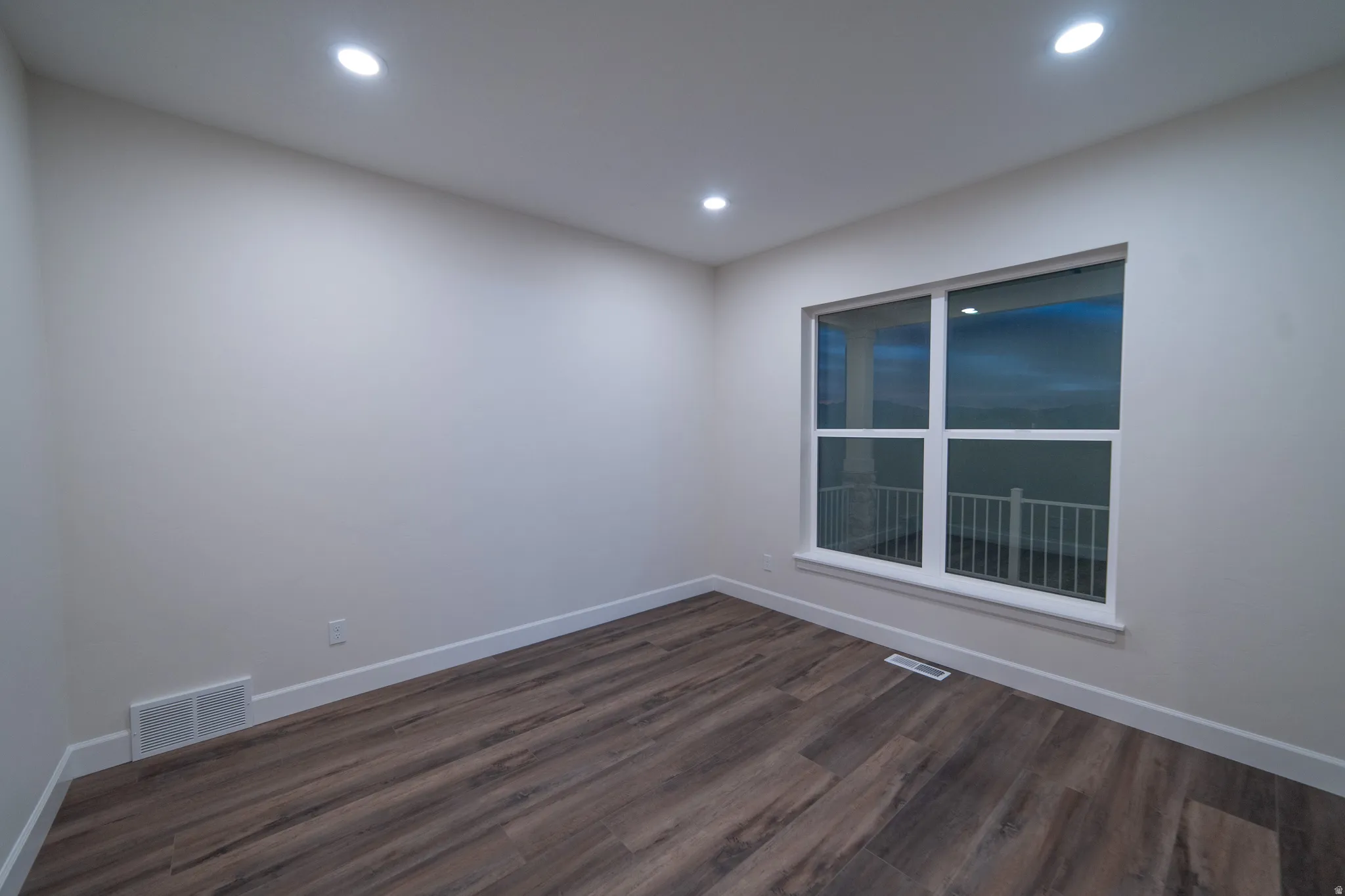 Spare room with dark wood finished floors and recessed lighting