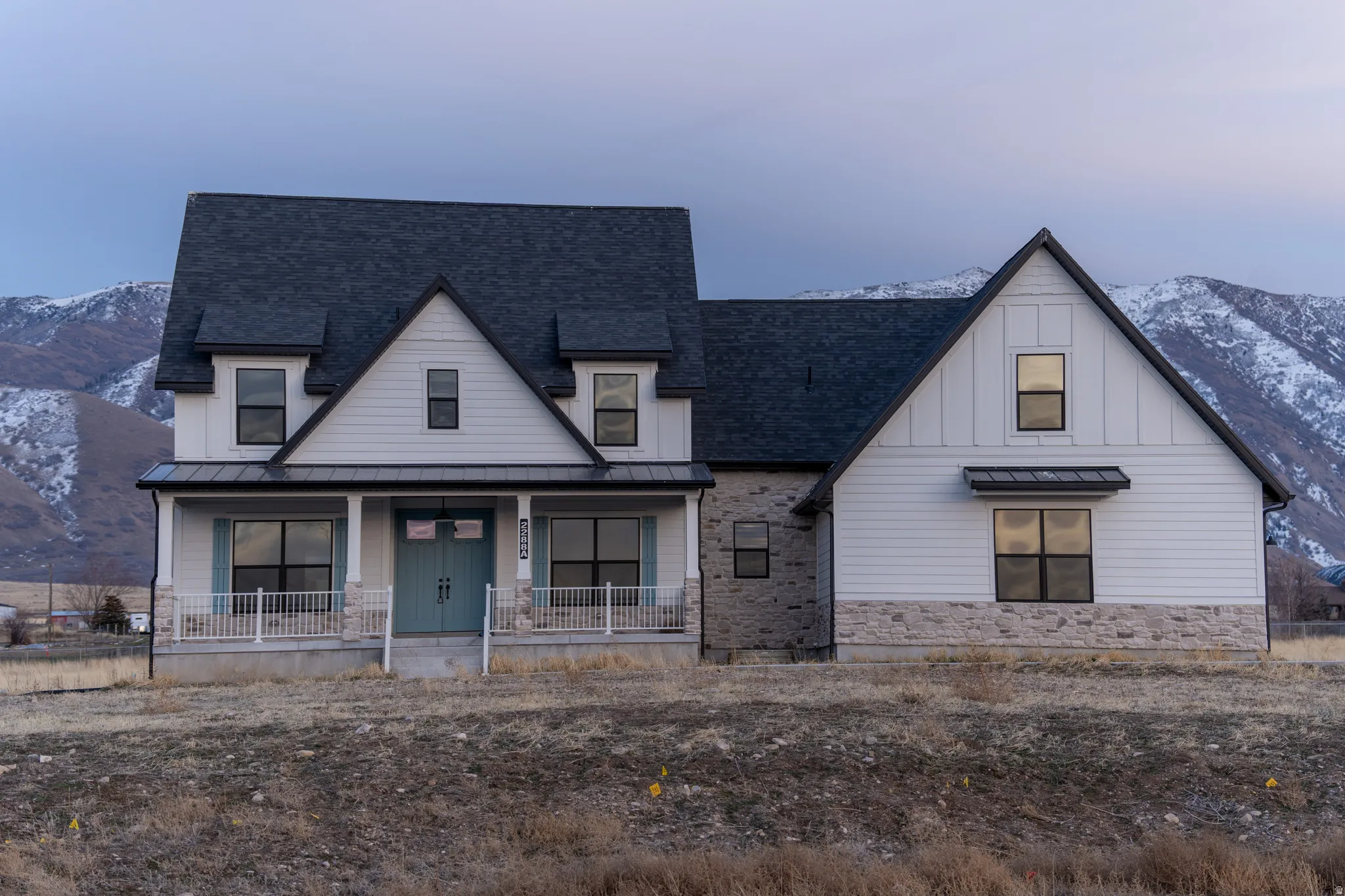 View of front of home featuring a standing seam roof, a porch, a metal roof, and a mountain view