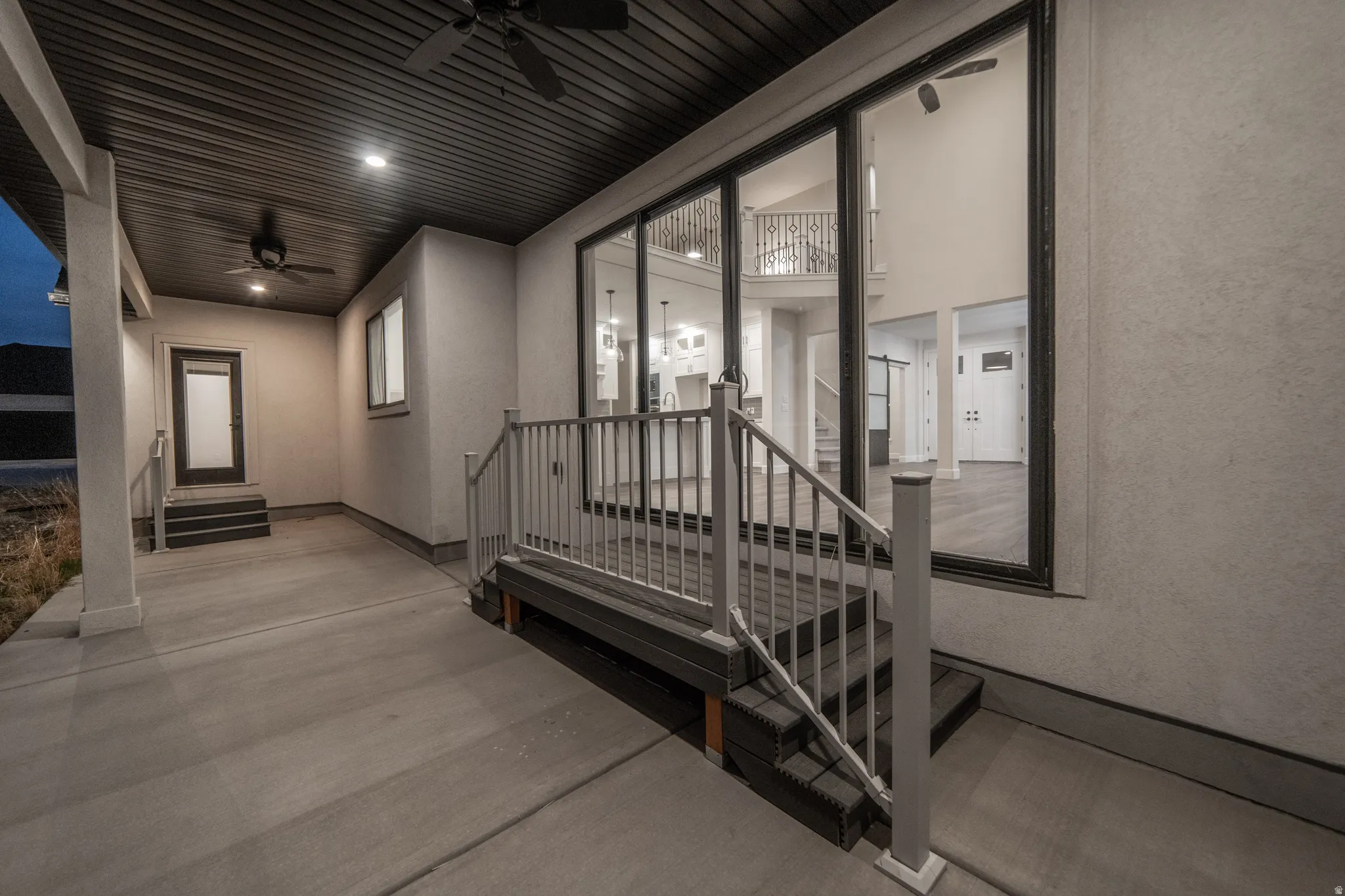 View of exterior entry with a ceiling fan