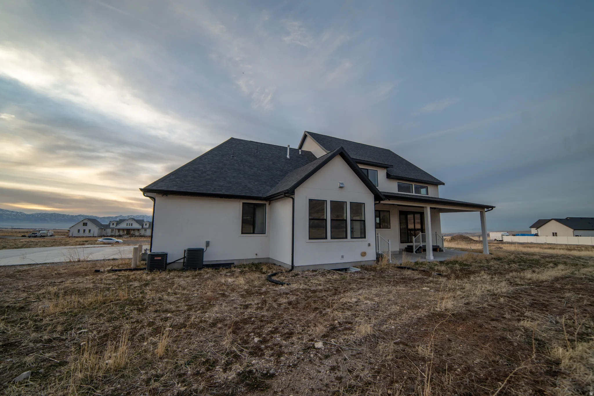 Back of property featuring a patio, roof with shingles, and stucco siding