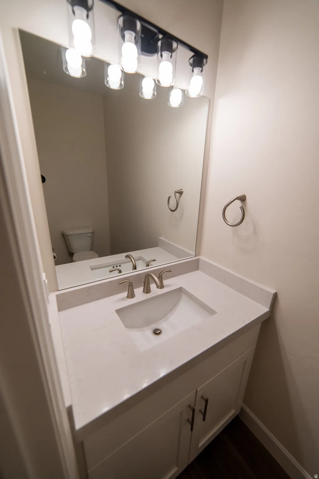Half bathroom with vanity and toilet