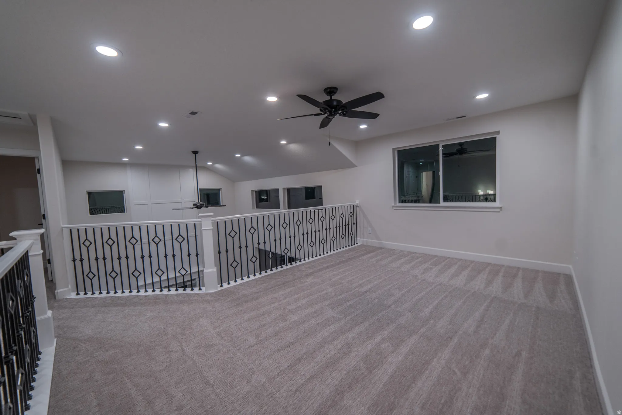 Unfurnished room featuring ceiling fan, light carpet, recessed lighting, and vaulted ceiling