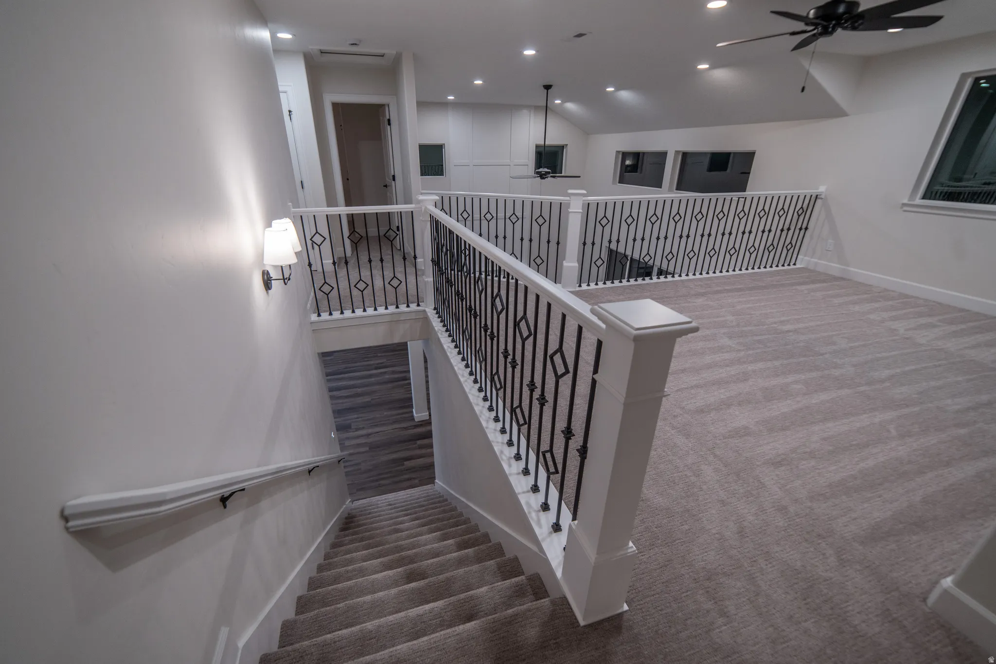 Stairs featuring a ceiling fan, carpet flooring, and recessed lighting
