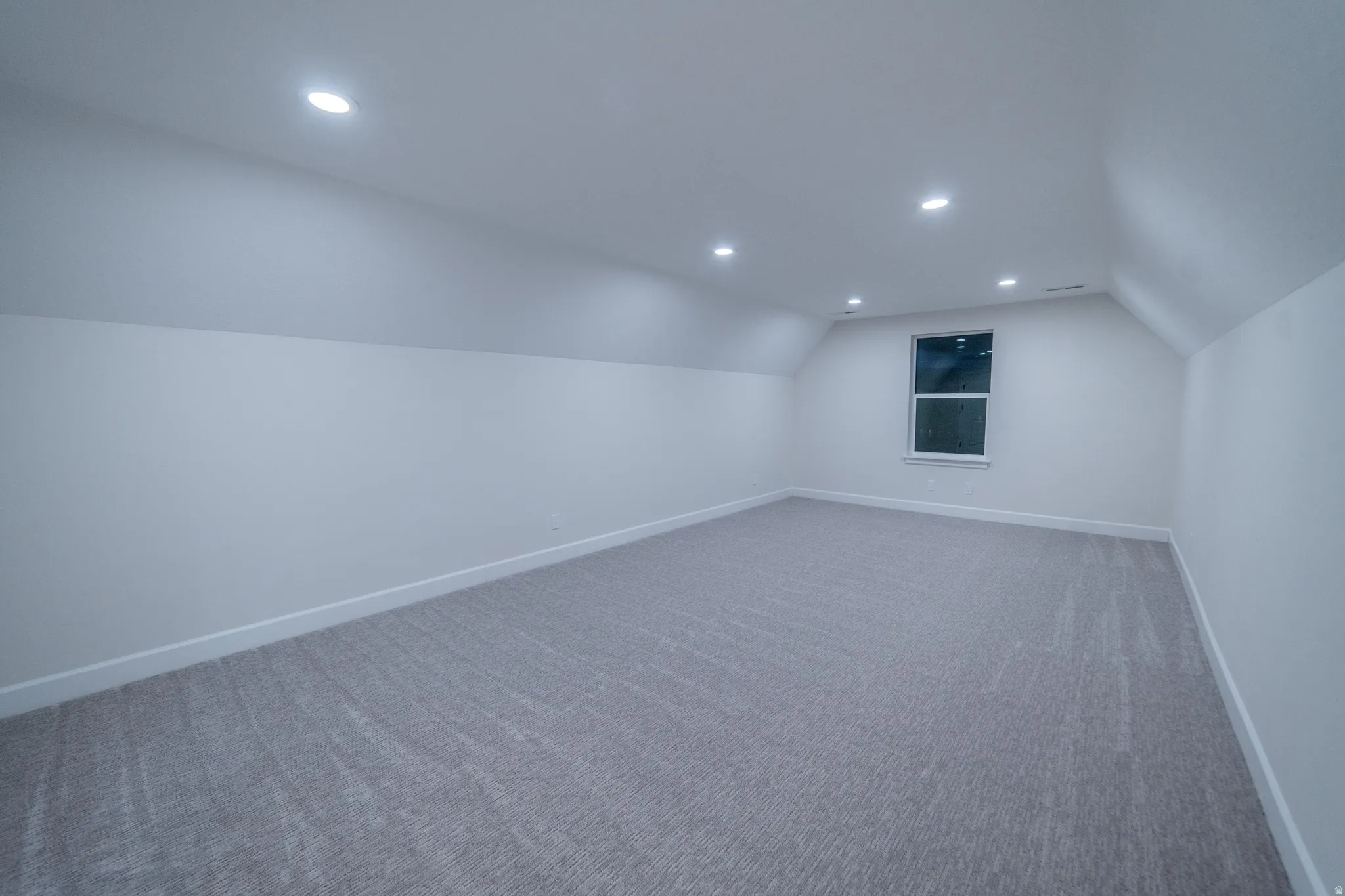 Bonus room featuring carpet flooring, recessed lighting, and vaulted ceiling