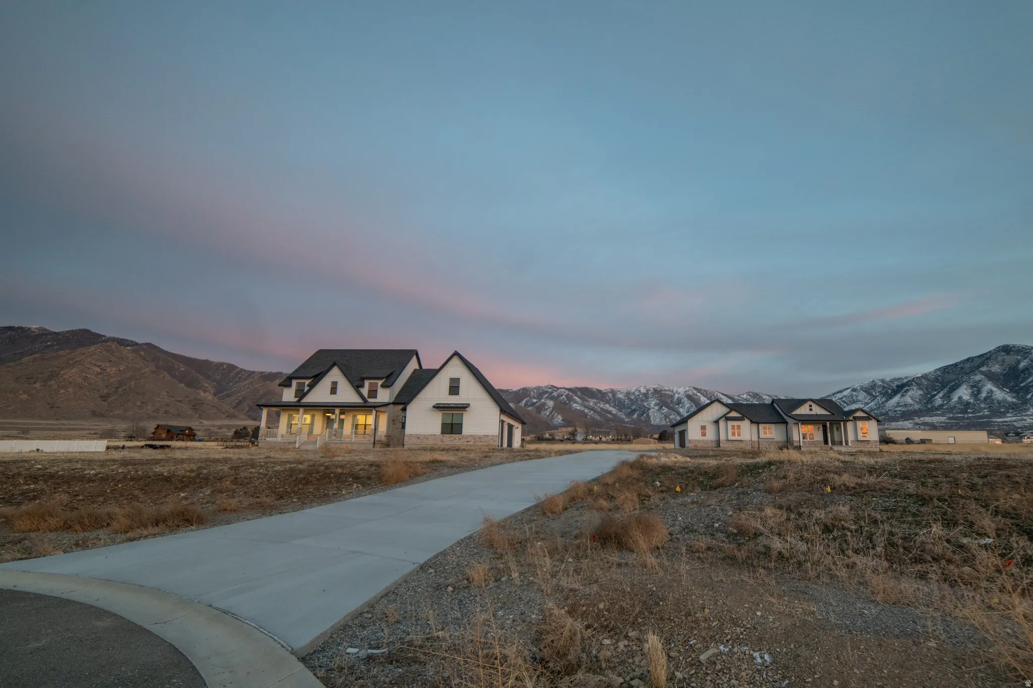 French provincial home featuring a mountain view and concrete driveway