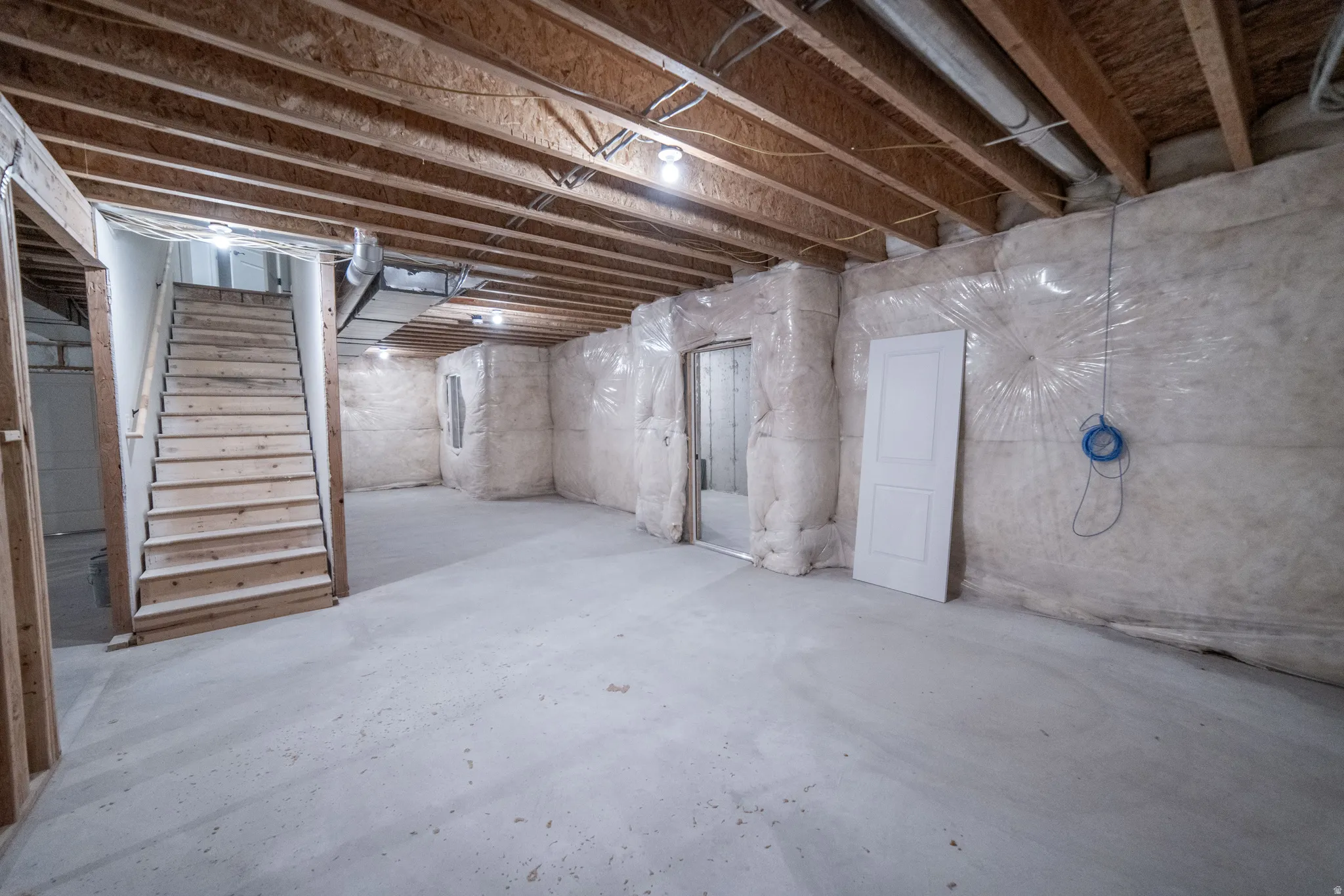 Unfinished basement with stairway