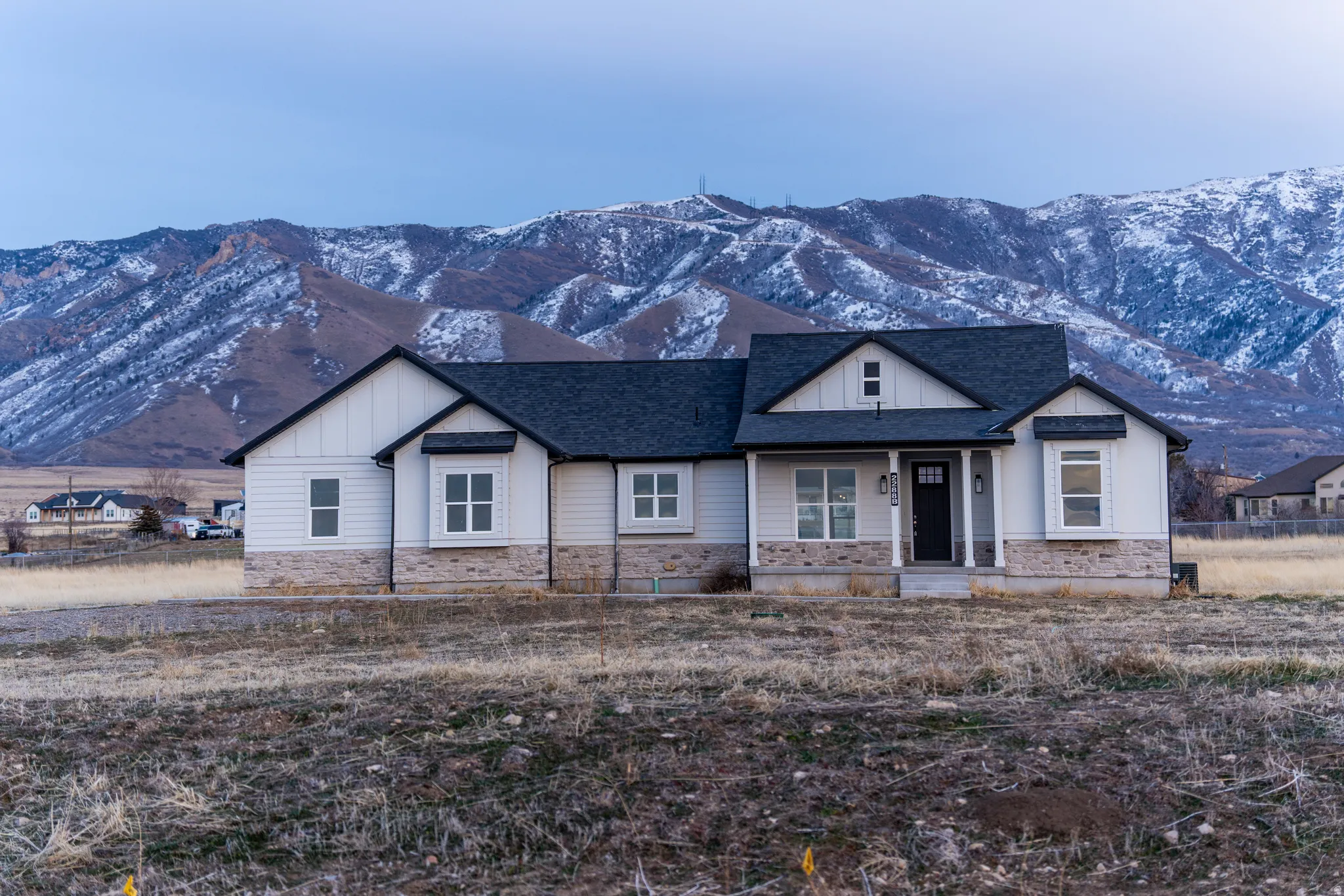 Modern farmhouse featuring a porch, a mountain view, board and batten siding, and roof with shingles