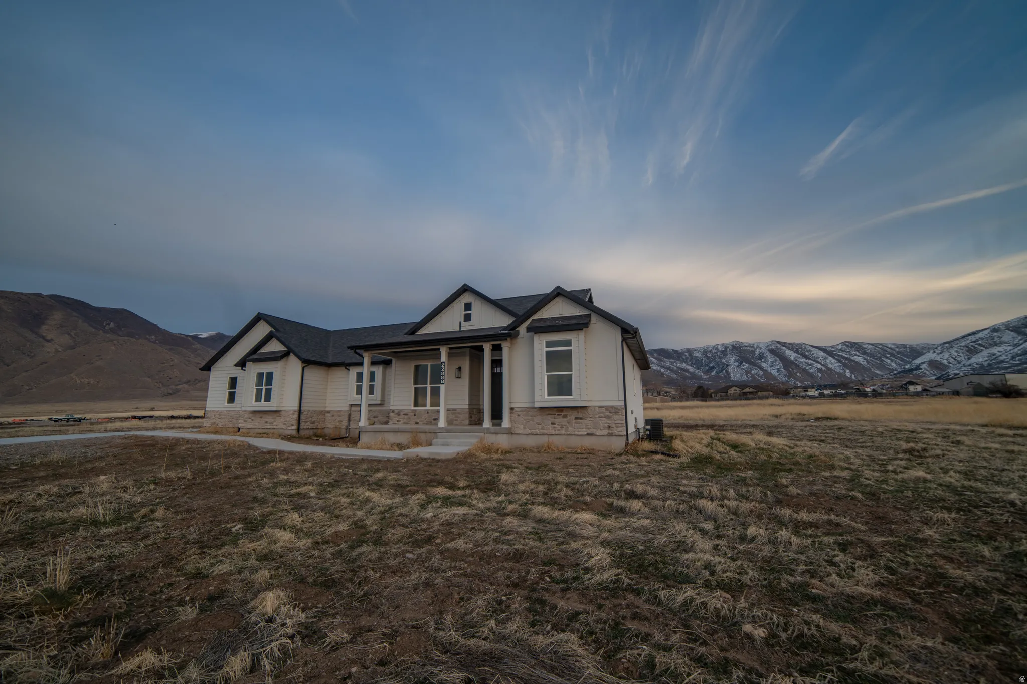 Bungalow featuring a mountain view, a porch, and stone siding