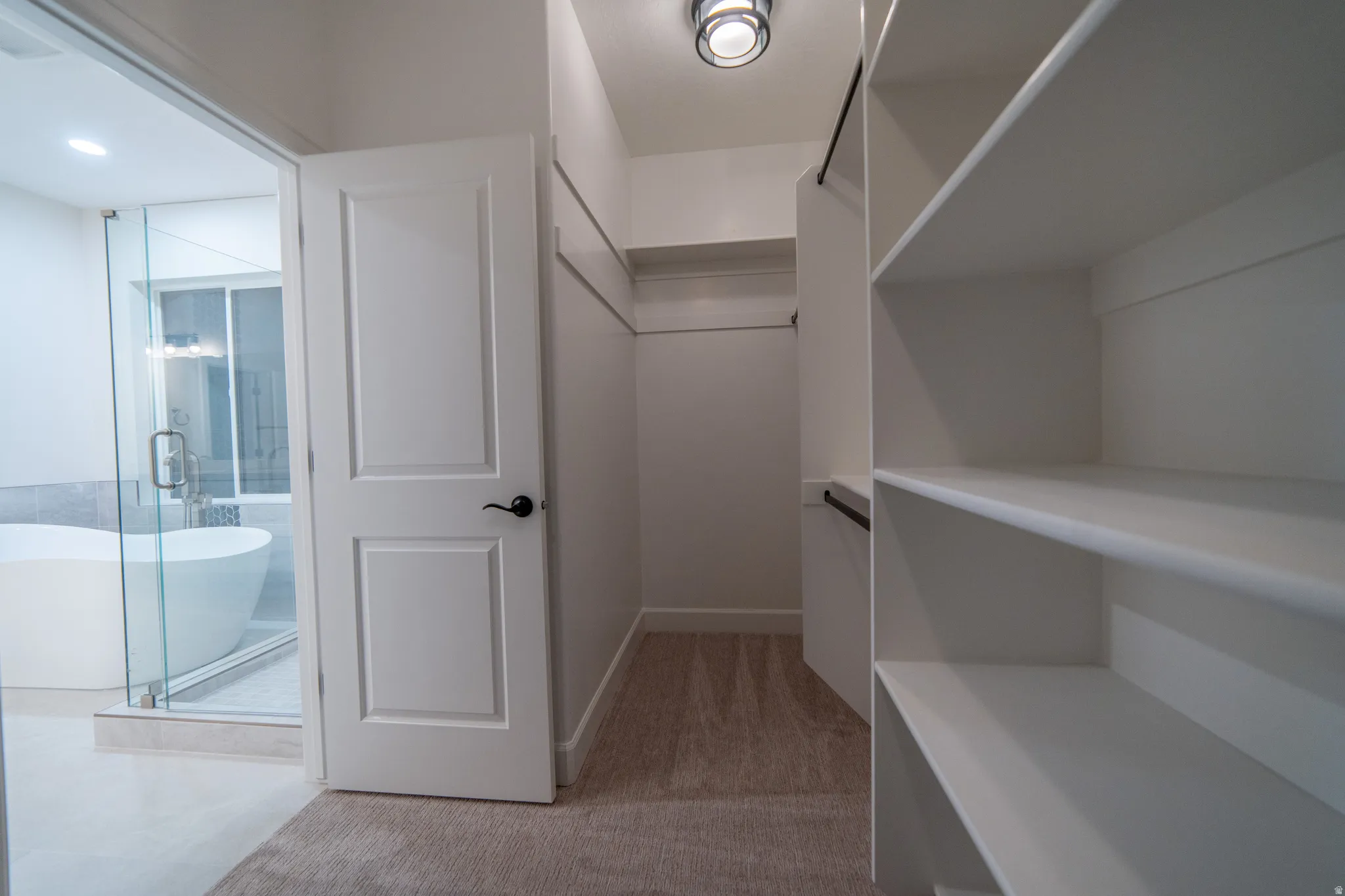 Spacious closet with light colored carpet