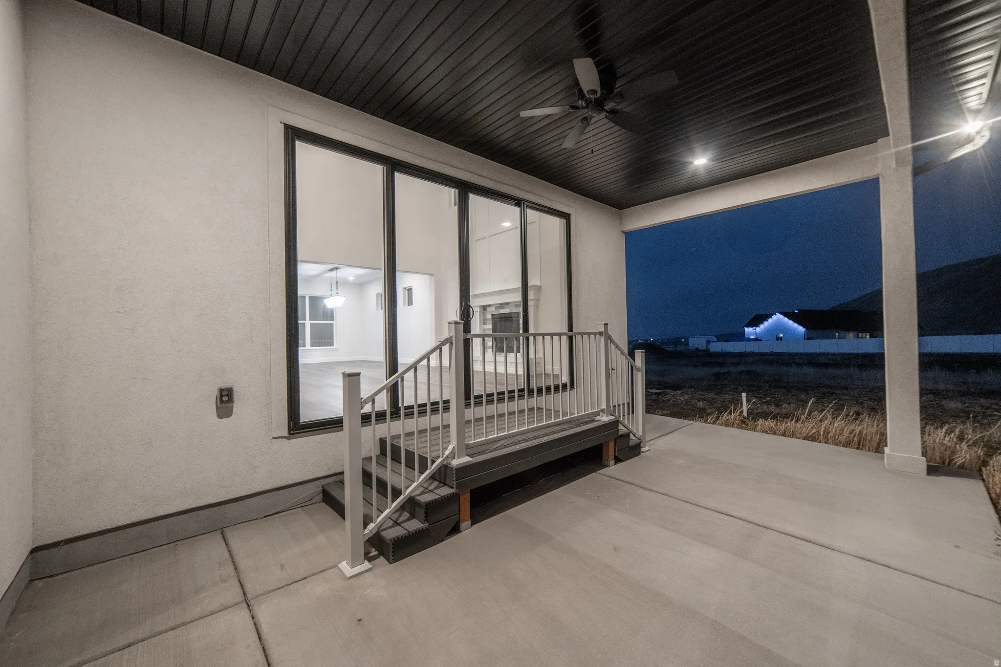 Patio at twilight with a ceiling fan and a patio area