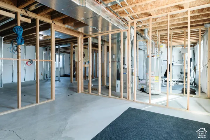 Unfinished basement with water heater and heating unit