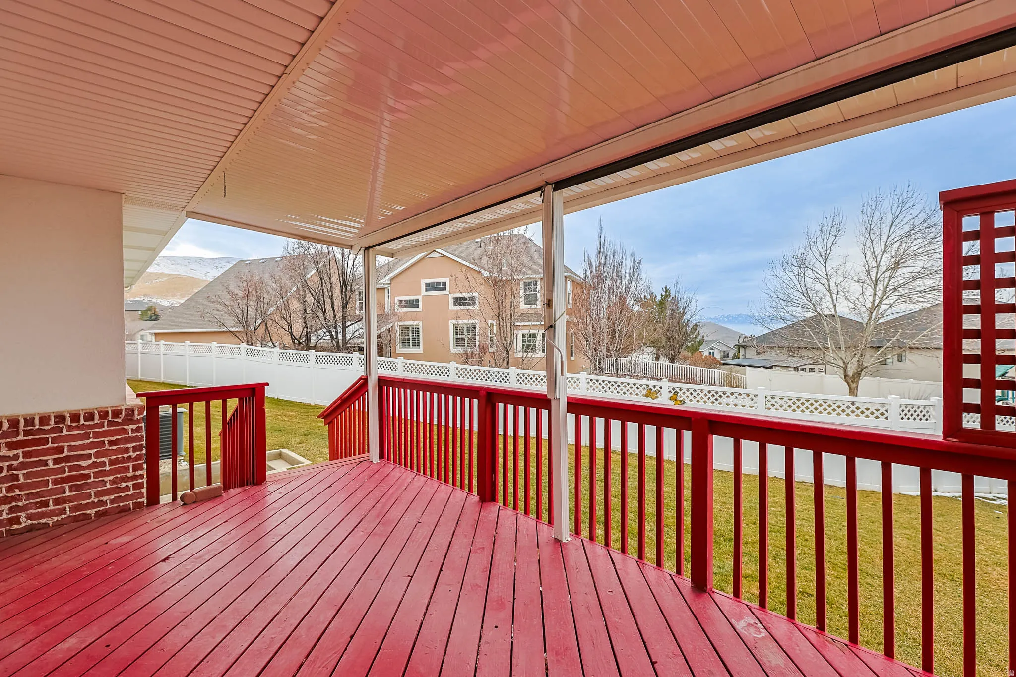 Deck with a fenced backyard and a residential view