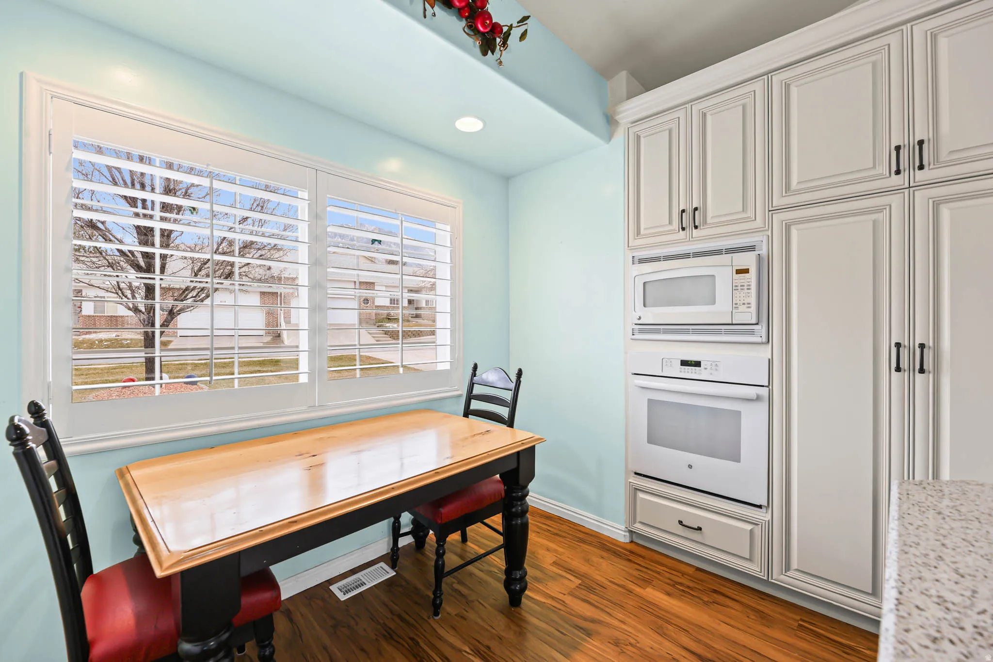 Dining space featuring dark wood-type flooring and recessed lighting