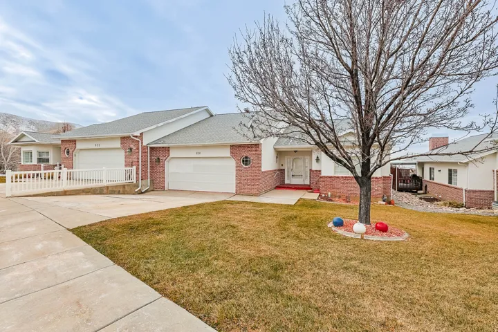 Single story home with concrete driveway, brick siding, an attached garage, and a shingled roof