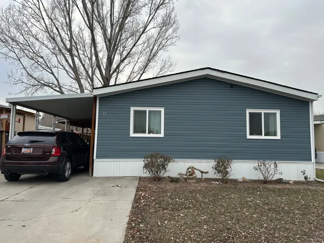 View of home's exterior featuring a carport and concrete driveway