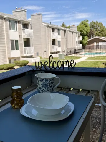 Private balcony offering views of the communal pool area and surrounding mature greenery
