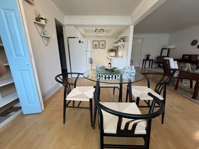 Dining room featuring light wood finished floors and ornamental molding