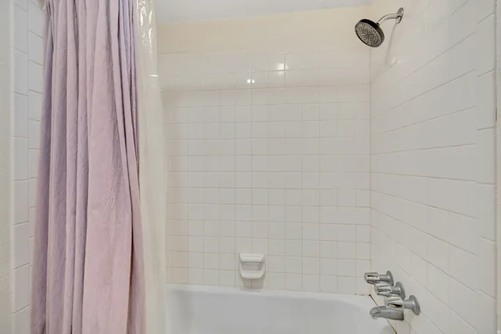 Full bath featuring shower / tub combo with curtain