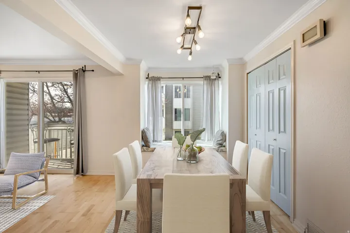 Dining room featuring light wood-style flooring and crown molding