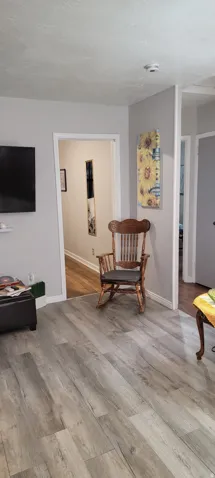 Living  room with baseboards and light wood-style flooring