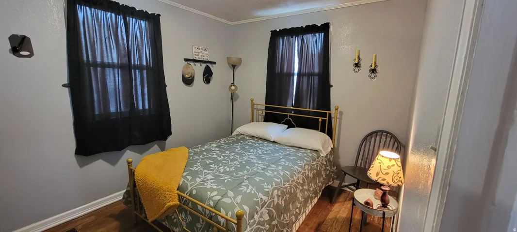 Bedroom featuring wood  floors.