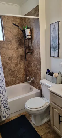 Full bathroom featuring shower / bath combo and vanity