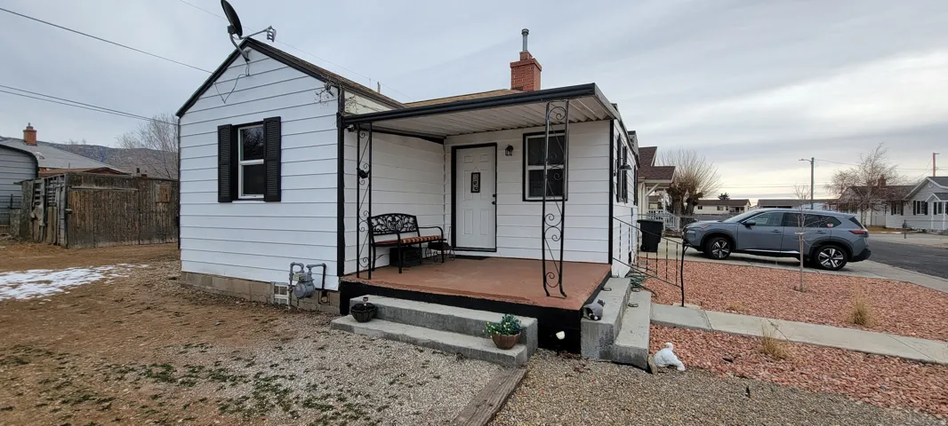 Bungalow-style house with a porch and a chimney