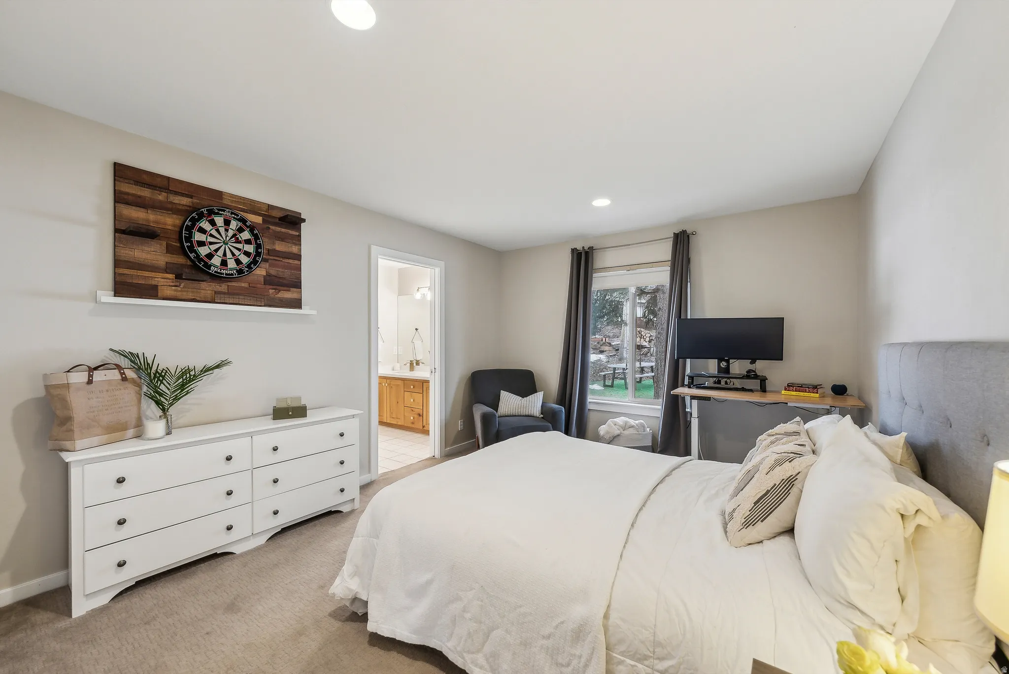 Recessed lighting, neutral wall tones, and carpet flooring