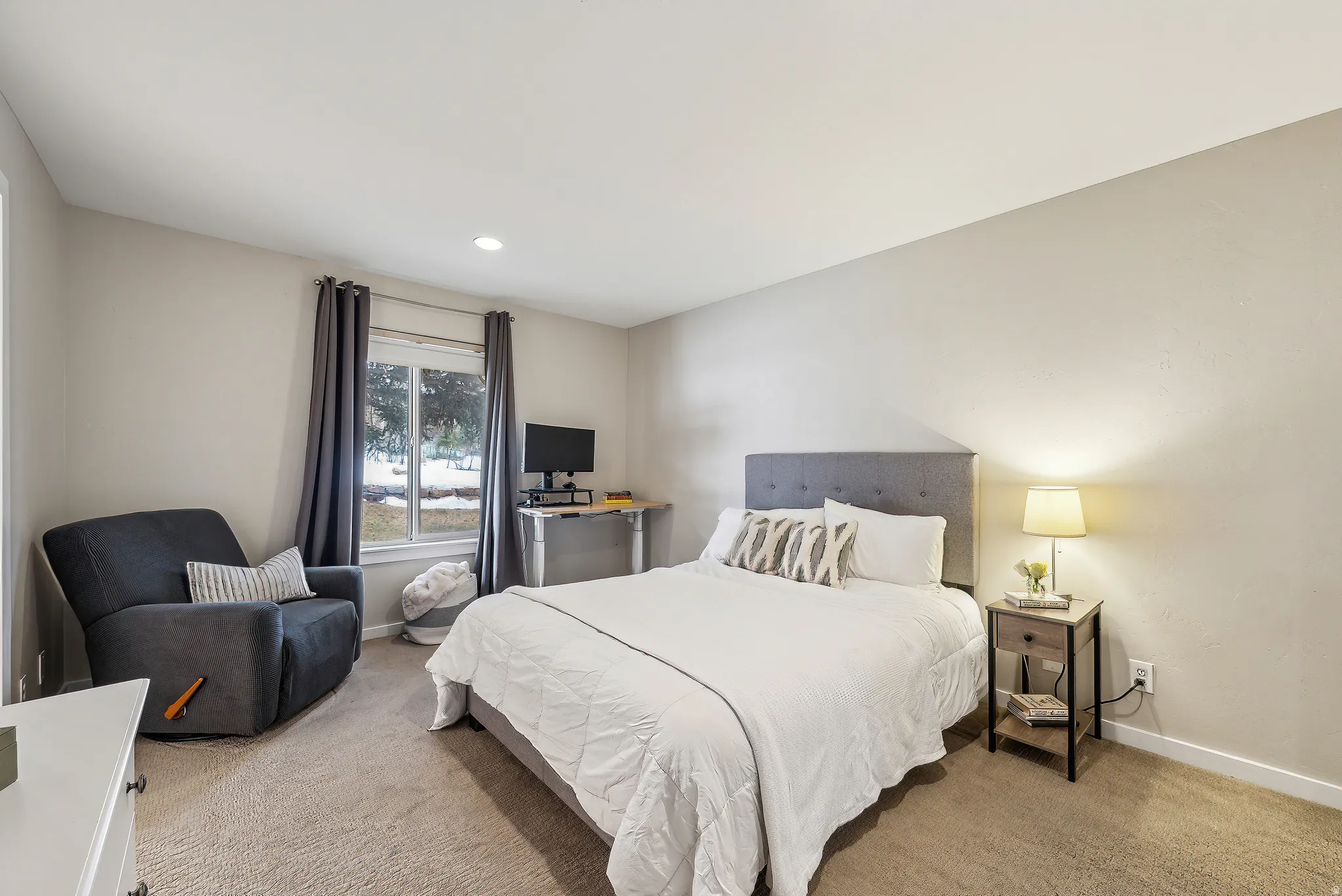 Recessed lighting, neutral wall tones, window with natural light, and carpeted flooring