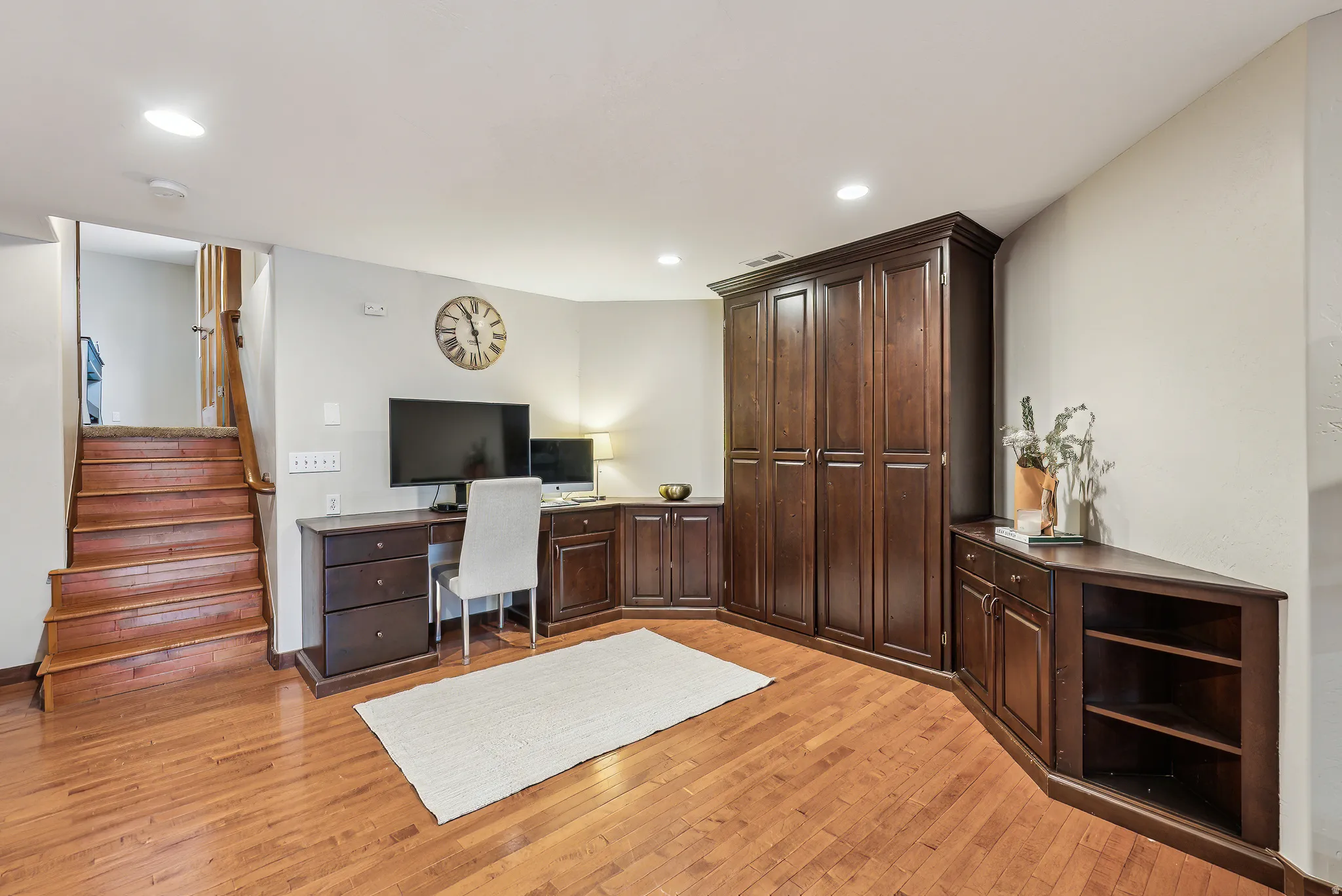 Home office with light wood-type flooring, recessed lighting, and built in study area