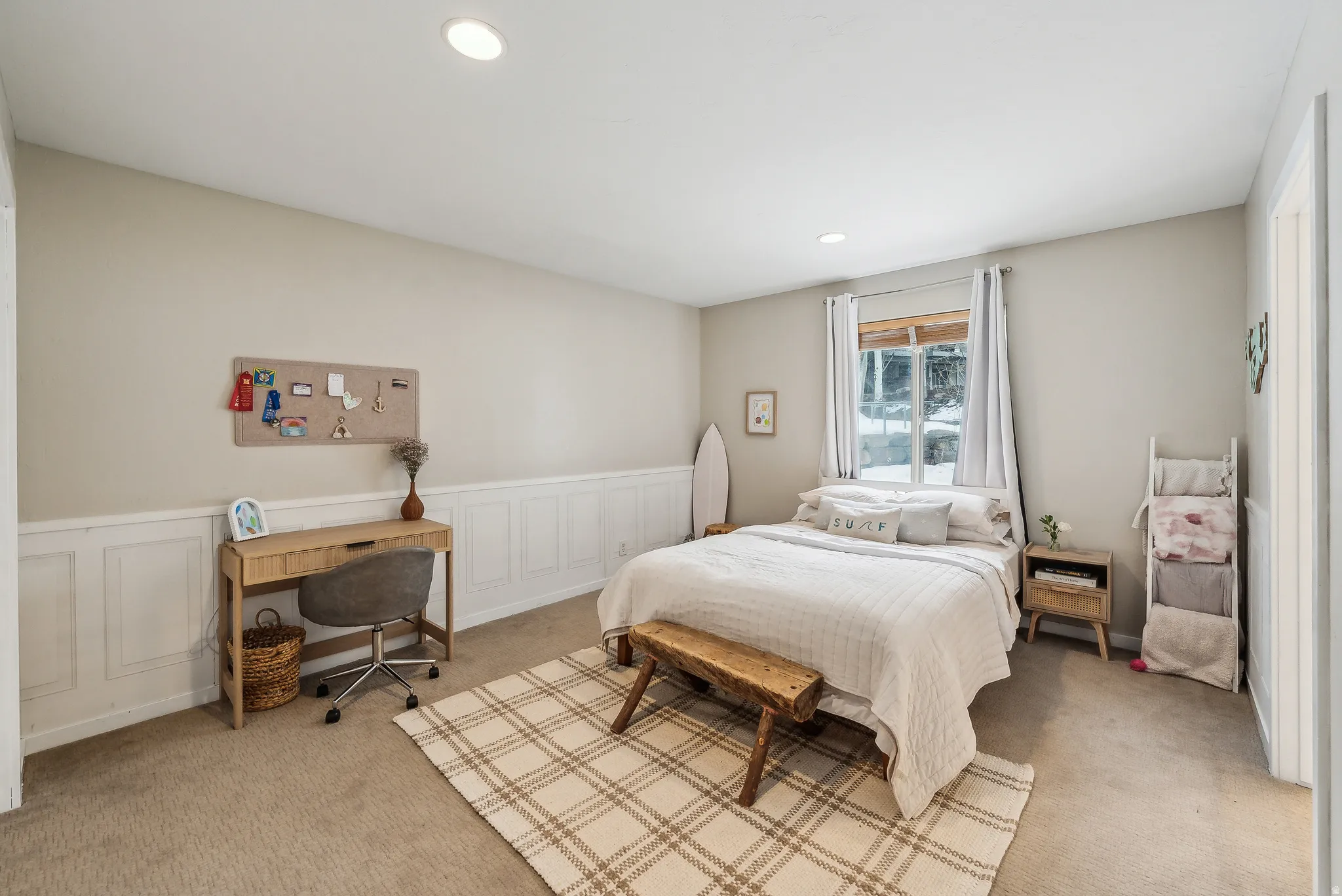 Recessed ceiling lighting, wainscoting wall detail, carpeted flooring, and a large window