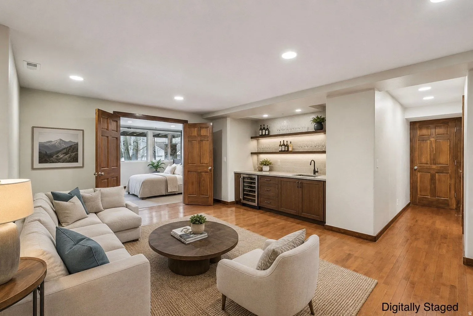 Wood-finish flooring, recessed lighting, and a built-in wet bar with a wine refrigerator
