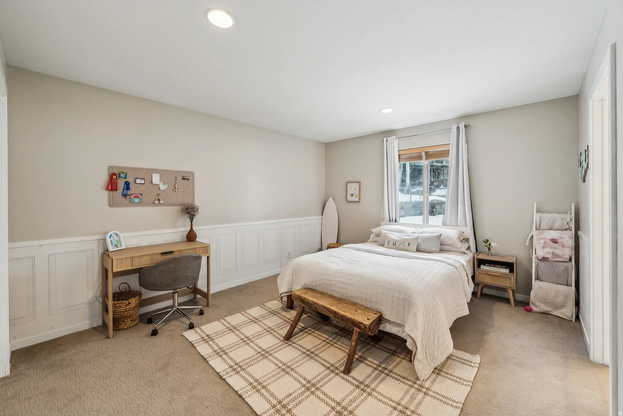 Bedroom featuring a wainscoted wall, a decorative wall, recessed lighting, a desk, and carpet floors