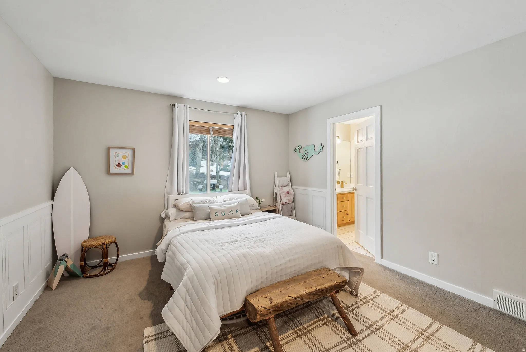 Recessed lighting, light gray walls, white wainscoting, and carpeted flooring