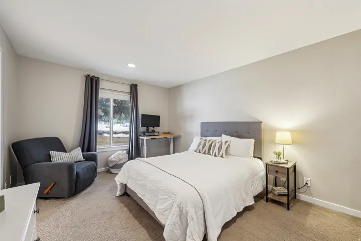 Recessed lighting, neutral wall tones, window with natural light, and carpeted flooring